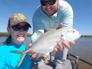 g42 proudly displaying small white fish caught on charter